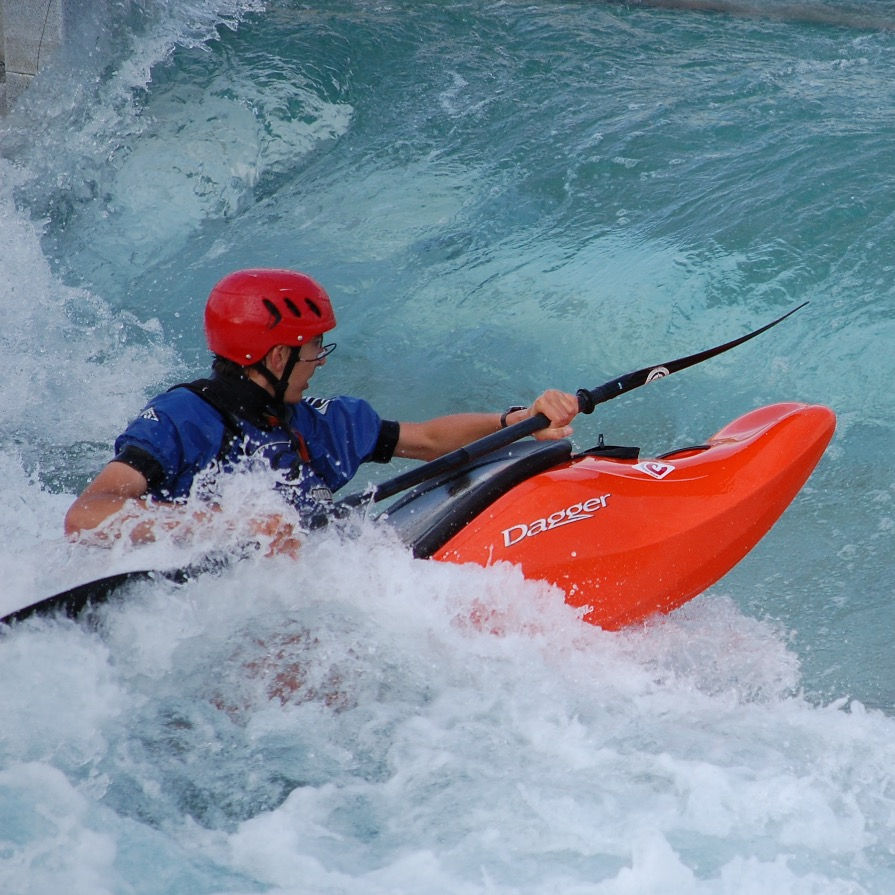 Club whitewater kayaker playing on a feature at Lee Valley Whitewater centre
